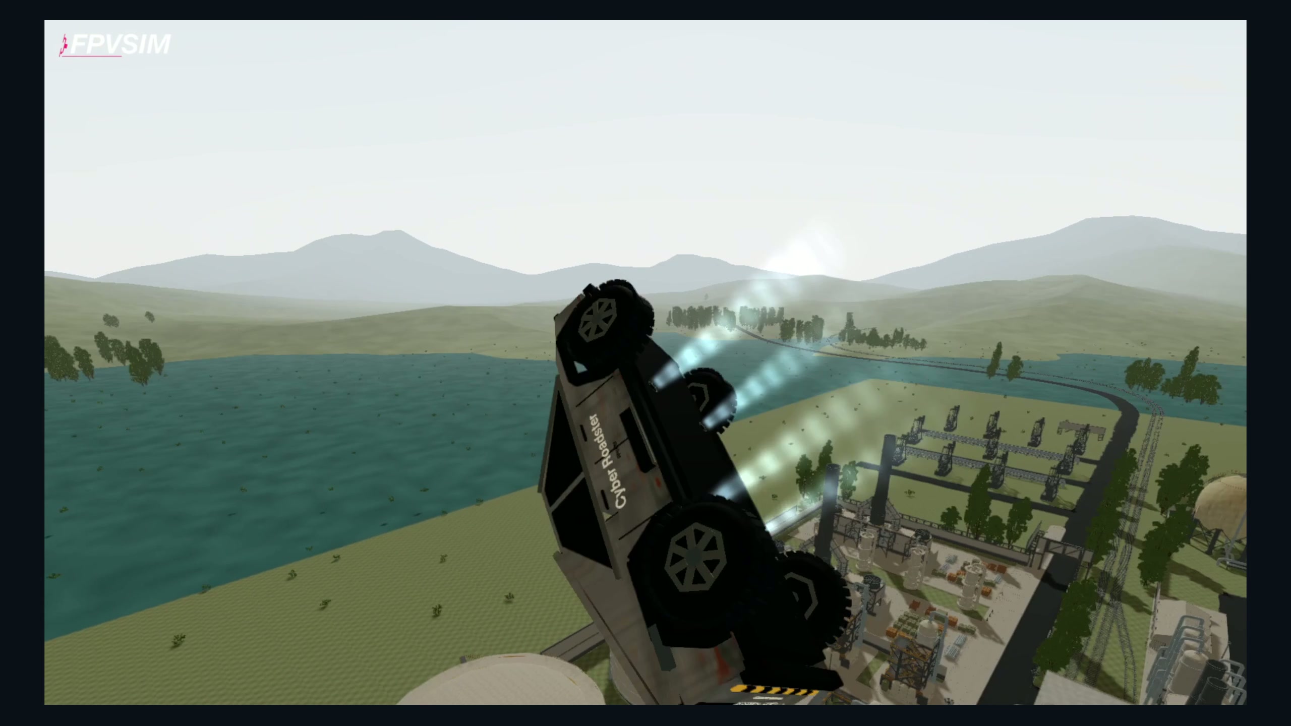 The Cyber Roadster rolling above a factory in FPVSIM, with bright pressure mist visible beneath the flying truck.